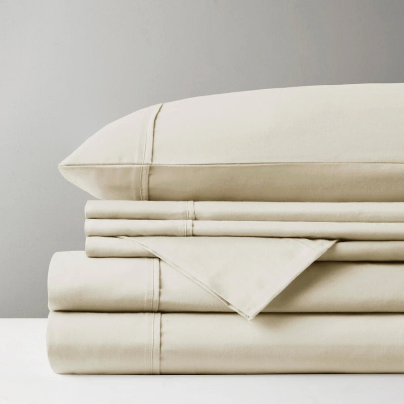 A pile of oatmeal sheet set, representing the luxurious comfort and stylish design of Park Avenue.