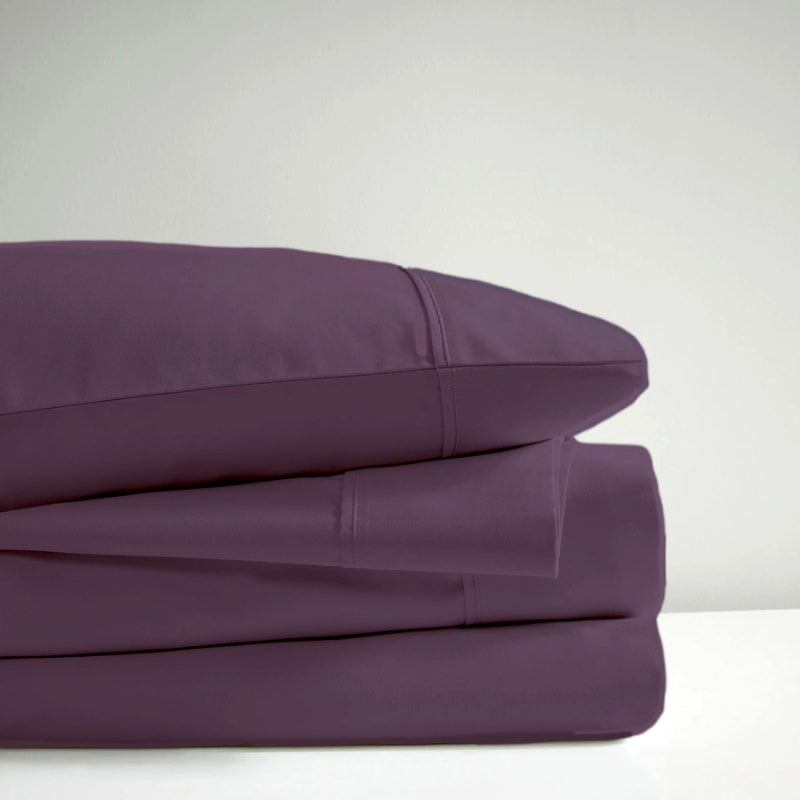 A pile of plum sheet set, representing the luxurious comfort and stylish design of Park Avenue.