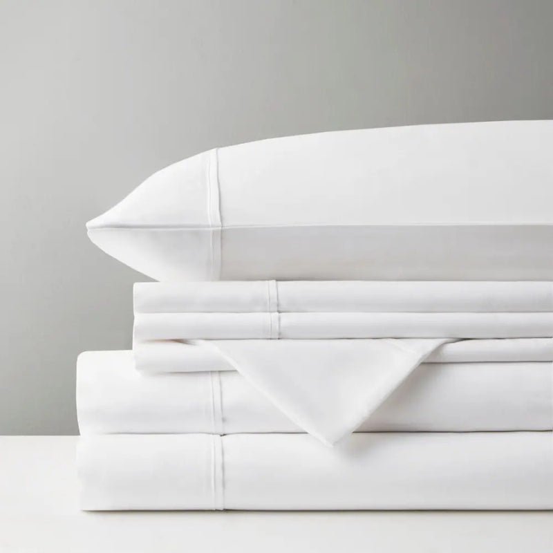 A pile of white sheet set, representing the luxurious comfort and stylish design of Park Avenue.