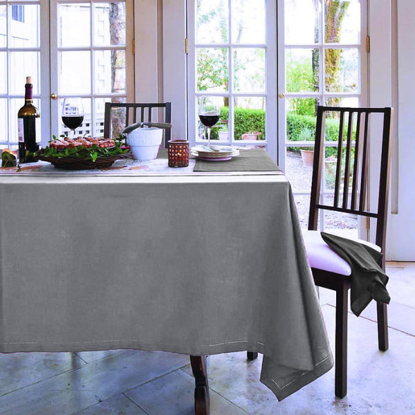 A beautifully set table adorned with a grey tablecloth, enhancing the elegance of the dining experience.