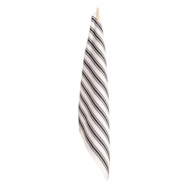 A chic black and white striped tea towel resting on a clean white surface, highlighting its sophisticated pattern and aesthetic appeal.