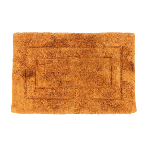 Luxurious rust bath mat, made of 100% cotton, offering softness and warmth for your feet in the bathroom.