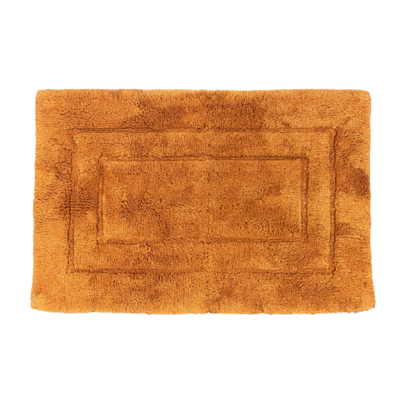 Luxurious rust bath mat, made of 100% cotton, offering softness and warmth for your feet in the bathroom.