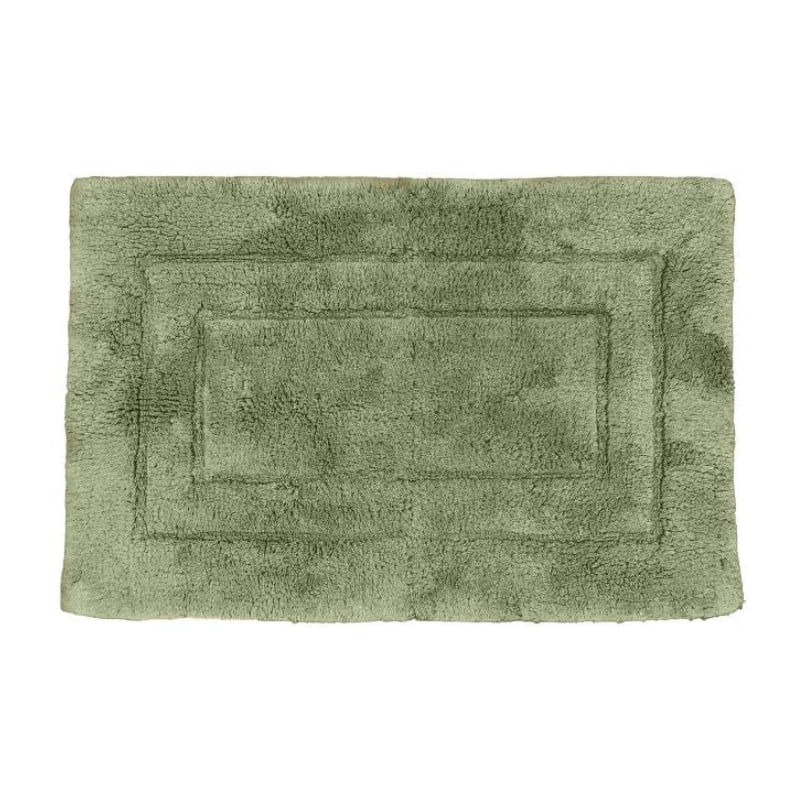 Luxurious teal bath mat, made of 100% cotton, offering softness and warmth for your feet in the bathroom.