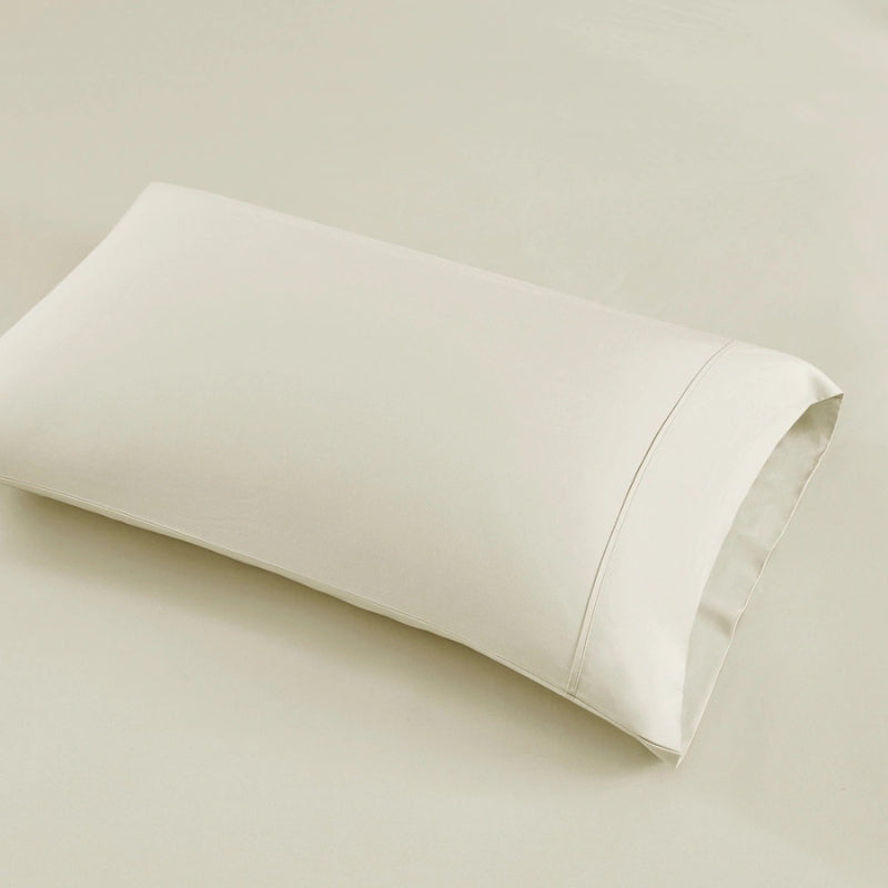 An ivory pillowcase highlighting the eco-friendly and breathable features of Renee Taylor.