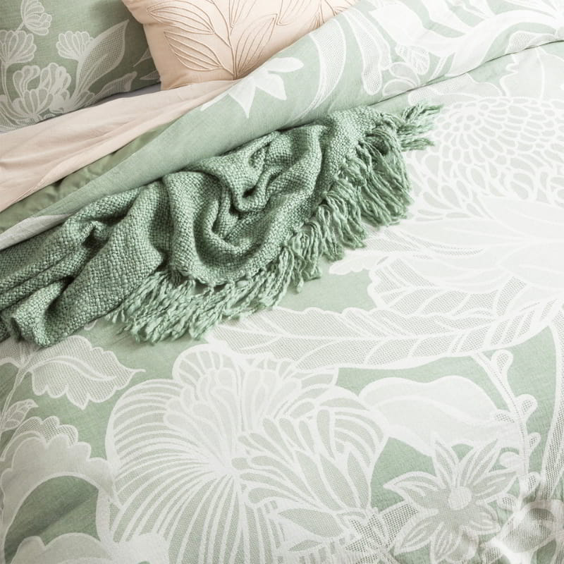 Exquisite bed adorned with a captivating green and white floral pattern, exuding elegance and charm.