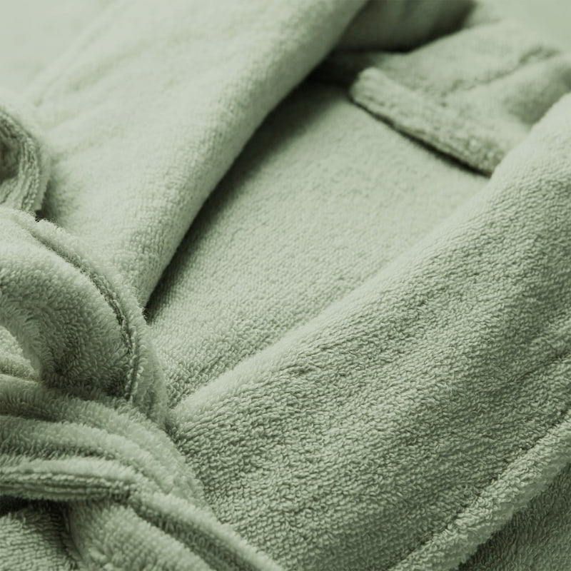 Detailed shot of a green robe featuring a sleek style and front pockets, perfect for a comfortable home spa experience.