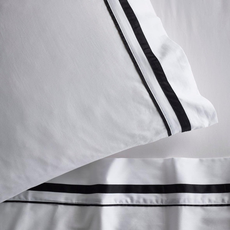 Opulent Renee Taylor Cloud Pillowcases featuring 1000-thread count Egyptian cotton, available in white with chic charcoal edges.