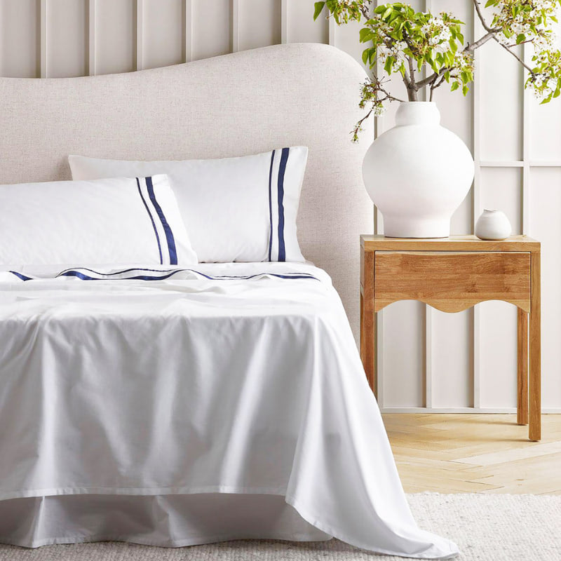 Opulent Renee Taylor Cloud Sheet Set featuring 1000-thread count Egyptian cotton, available in white with chic navy edges.