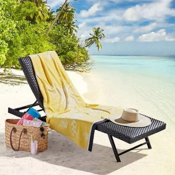 A beach chair adorned with a vibrant bee beach towel, showcasing luxurious comfort and stylish design for relaxation.