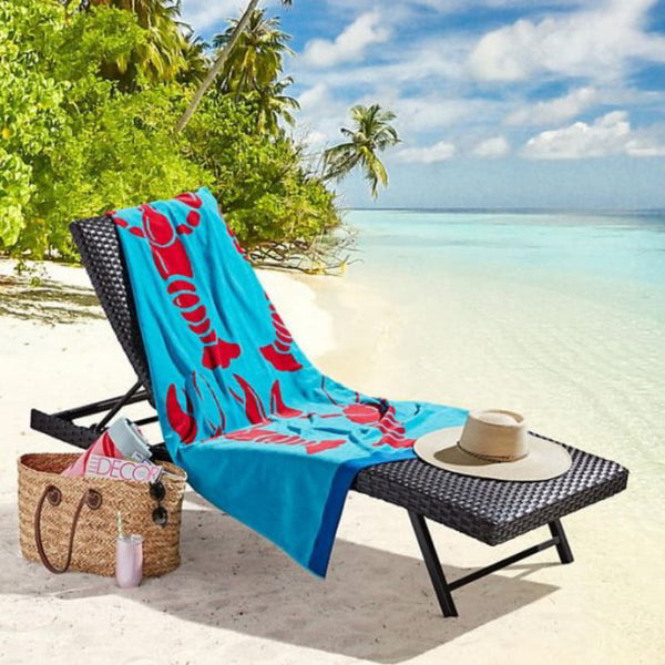 A beach chair adorned with a vibrant cray fish beach towel, showcasing luxurious comfort and stylish design for relaxation.