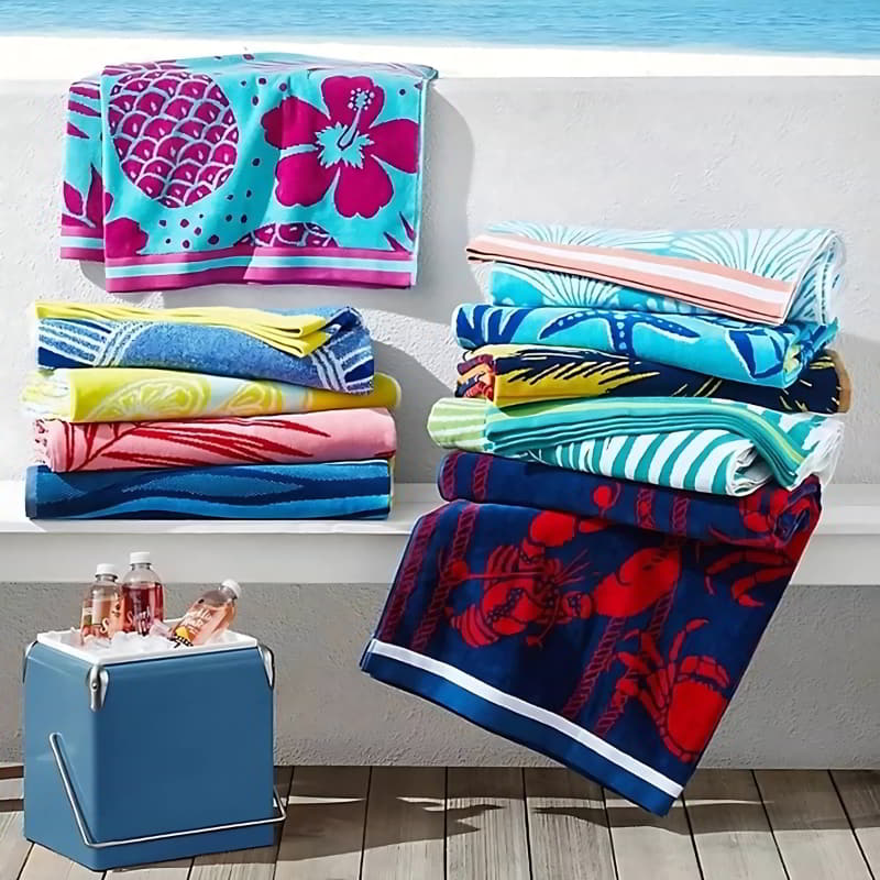 Luxurious beach towels, including the fresh catch design, that are ideal for drying off or relaxing in style at the beach or spa.