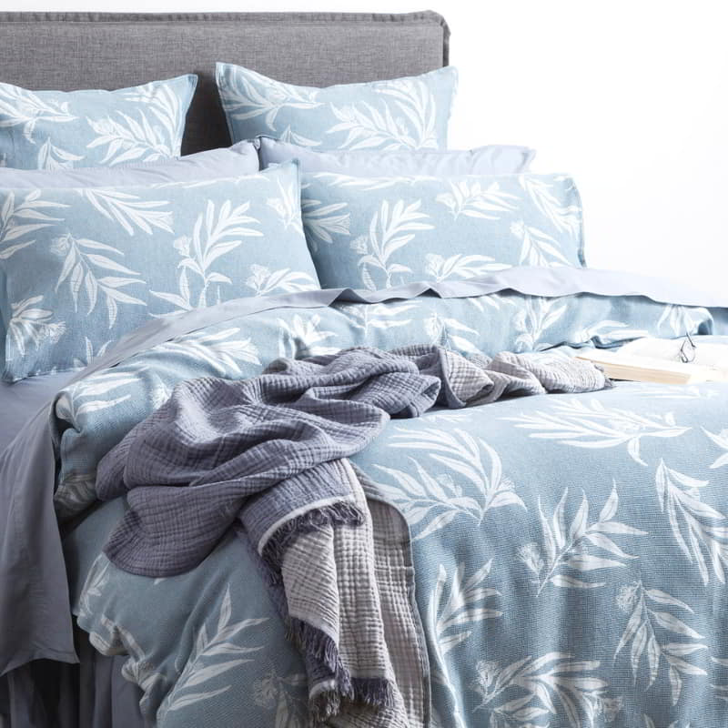 Indulge in the opulence of a native cotton french blue quilt cover set, featuring a stunning leaf print design.