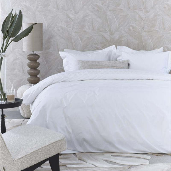 alt="A sophisticated white quilt cover set featuring a narrow horizontal band with embroidered geometric pattern"