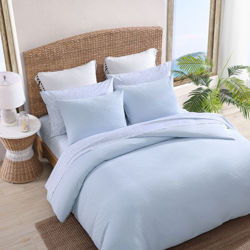 Top view of a blue quilt cover set from Tommy Bahama creates a serene oasis for your bedroom. 