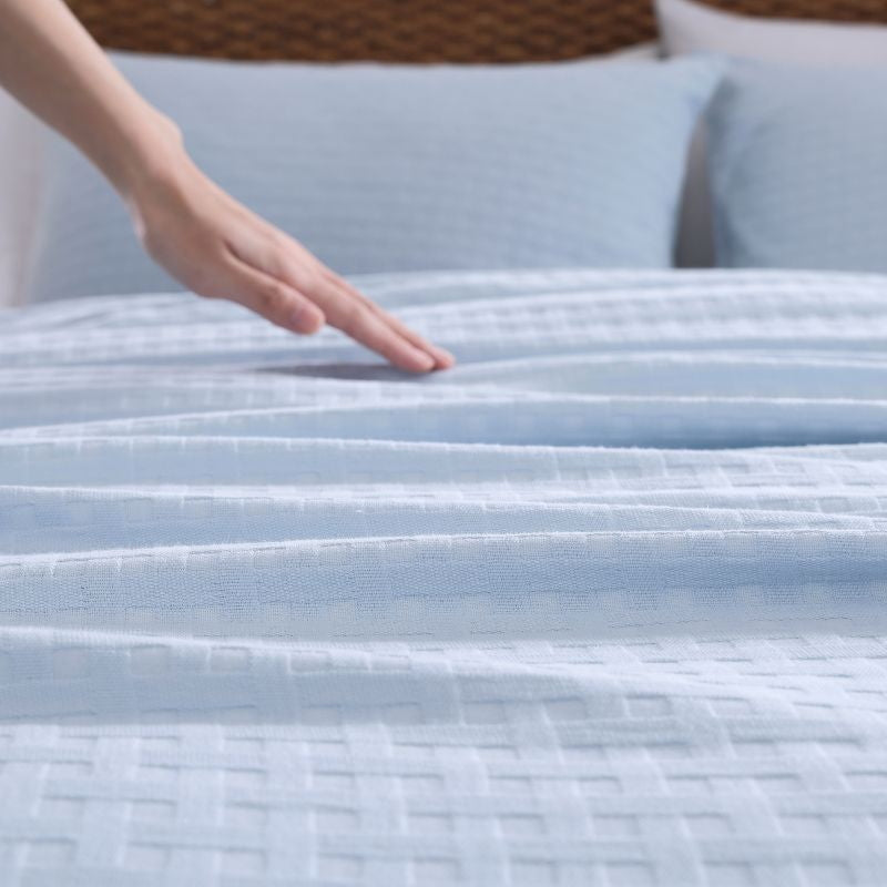 Close up details of a blue quilt cover set from Tommy Bahama creates a serene oasis for your bedroom. 