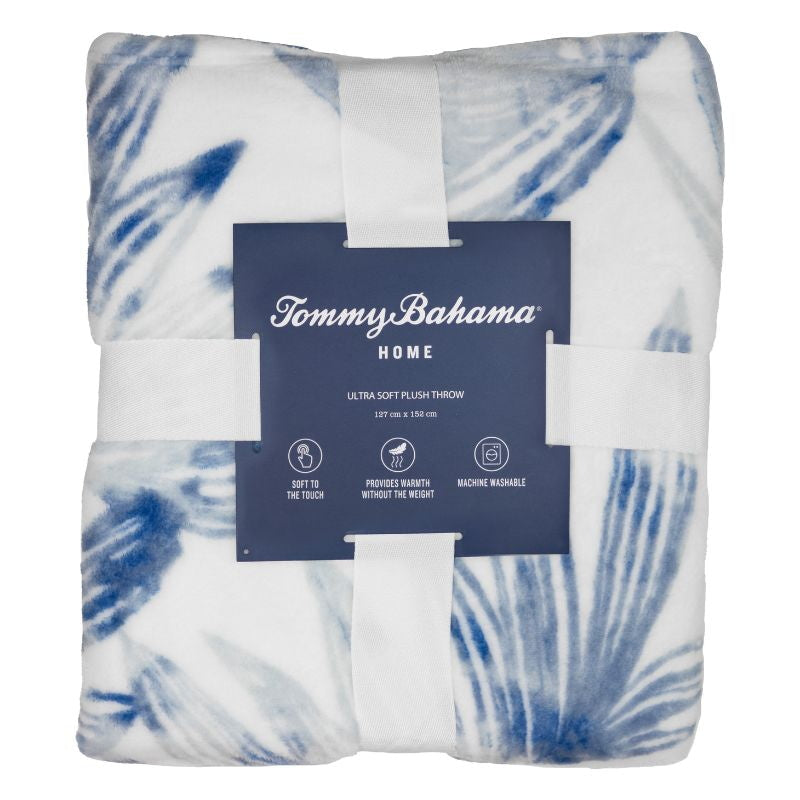 Packaging details of a soft plush polyester throw with tranquil blues palm leaf design for warmth.