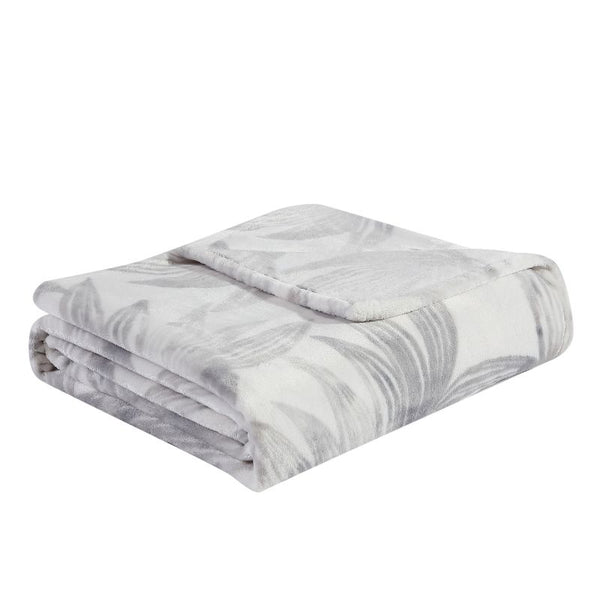 Soft plush polyester throw with soft grey hue palm leaf design for warmth.