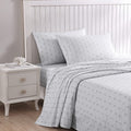 An elegance grey bed sheets featuring a light stripe and palm design.