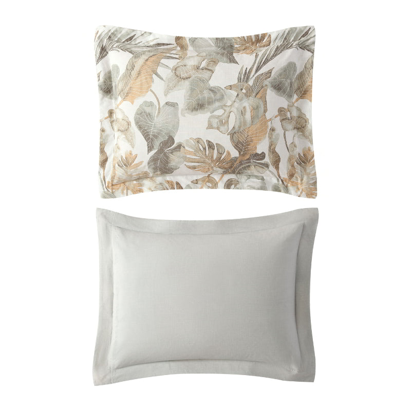 A tropical print pillowcase featuring green and gold tones enhances a cosy bedroom atmosphere for restful sleep.