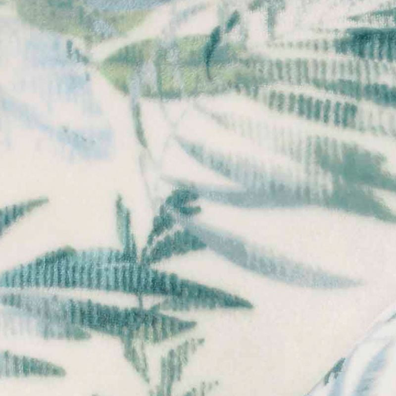 Detailed view of a super-soft, white and green tropical print blanket, featuring lush foliage, perfect for adding a touch of paradise to your home decor.