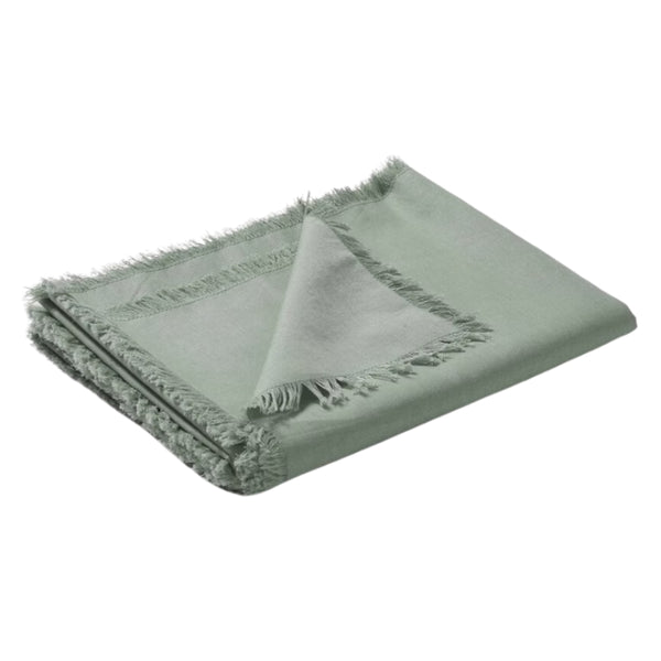 Timeless green linen cotton table runner with exquisite fringed borders, enhancing the beauty of both casual and formal dining.