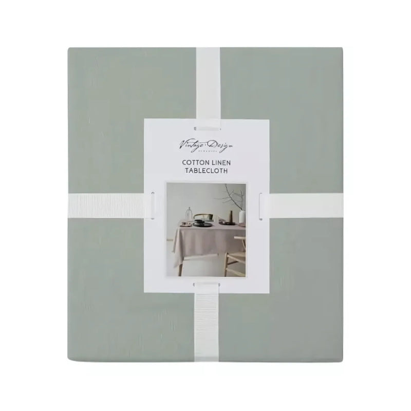 Packaging details of a green tablecloth made of linen and cotton, featuring a soft feel, fringe edges, and a versatile design for any occasion.