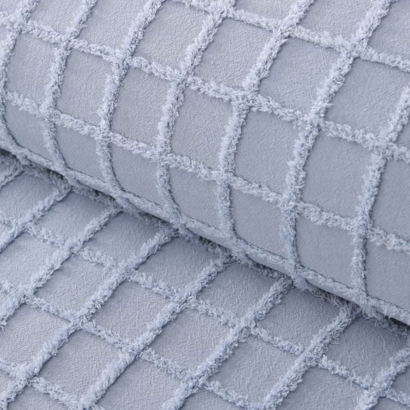 Detailed shot of a powder blue quilt cover and pillowcases in a stylish and modern design add a touch of elegance to your bedroom.