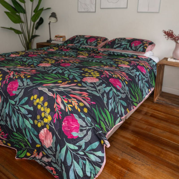 bright colour floral coverlet on a bed