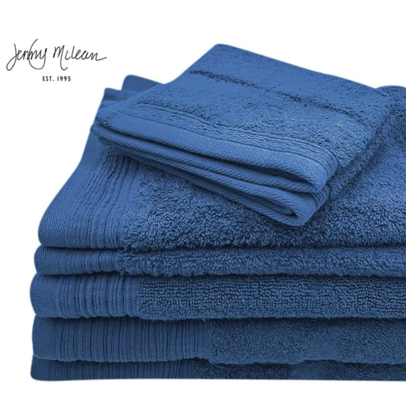 Luxurious navy towels stacked neatly, emphasizing softness and absorbency for a relaxing bath.