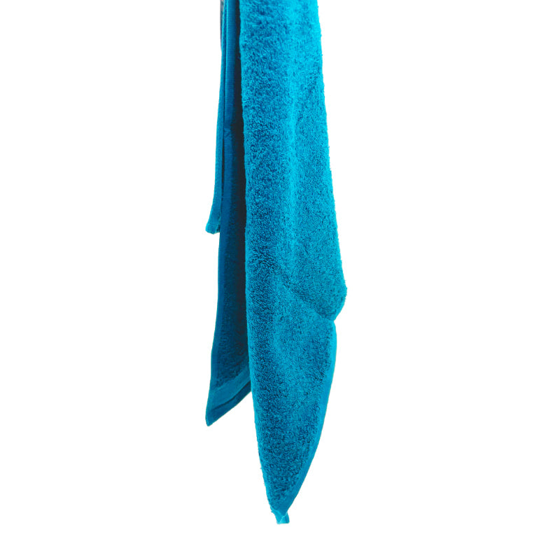 An aqua bath sheet highlighting its absorbency and chic French boutique-inspired design.