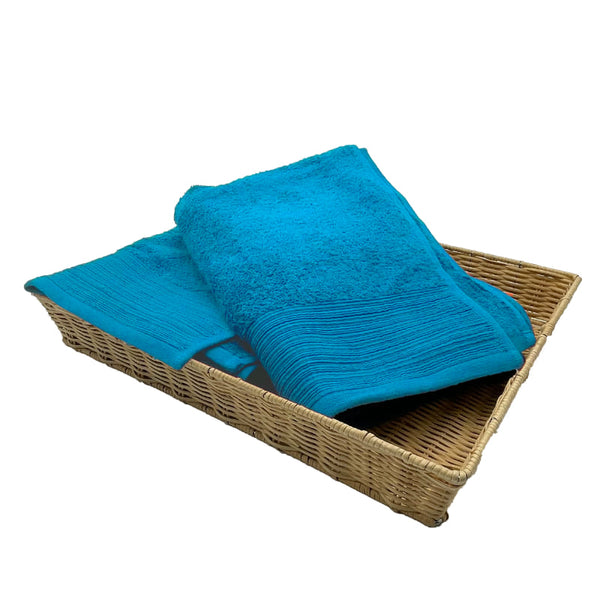 Two aqua bath towels elegantly placed in a basket, highlighting their luxurious softness and stylish appeal for a refined bathroom.