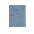 A soft baby blue bath mat enhancing the calm and luxurious feel of a spa-inspired bathroom.