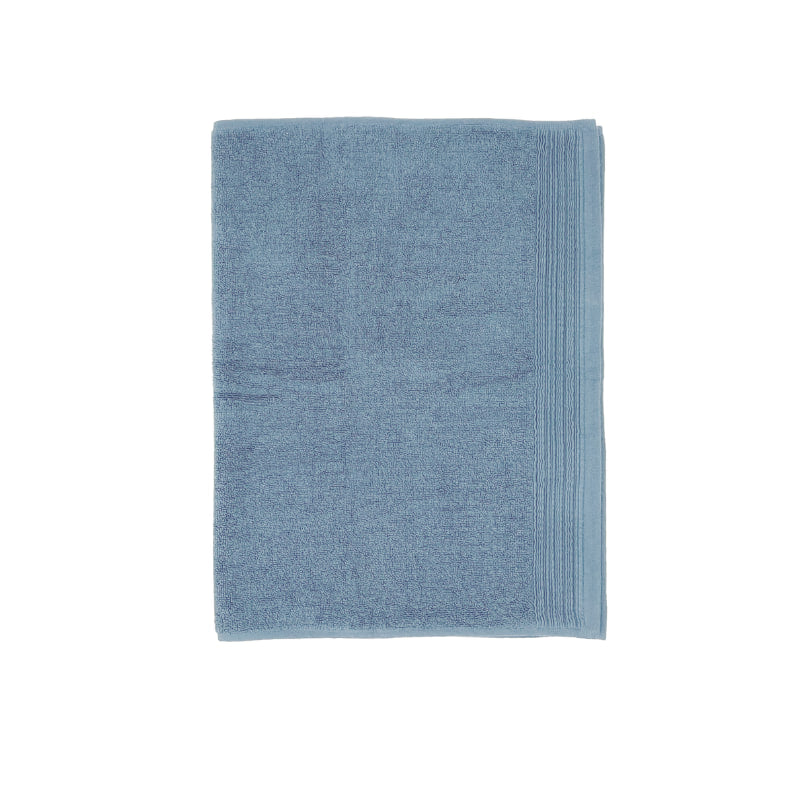 A soft baby blue bath mat enhancing the calm and luxurious feel of a spa-inspired bathroom.