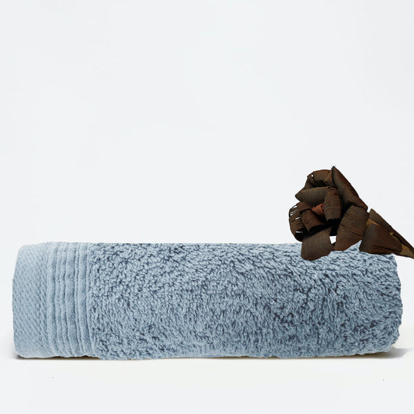 A baby blue face towel showcasing elegance with a wide sheared border for a luxurious touch.