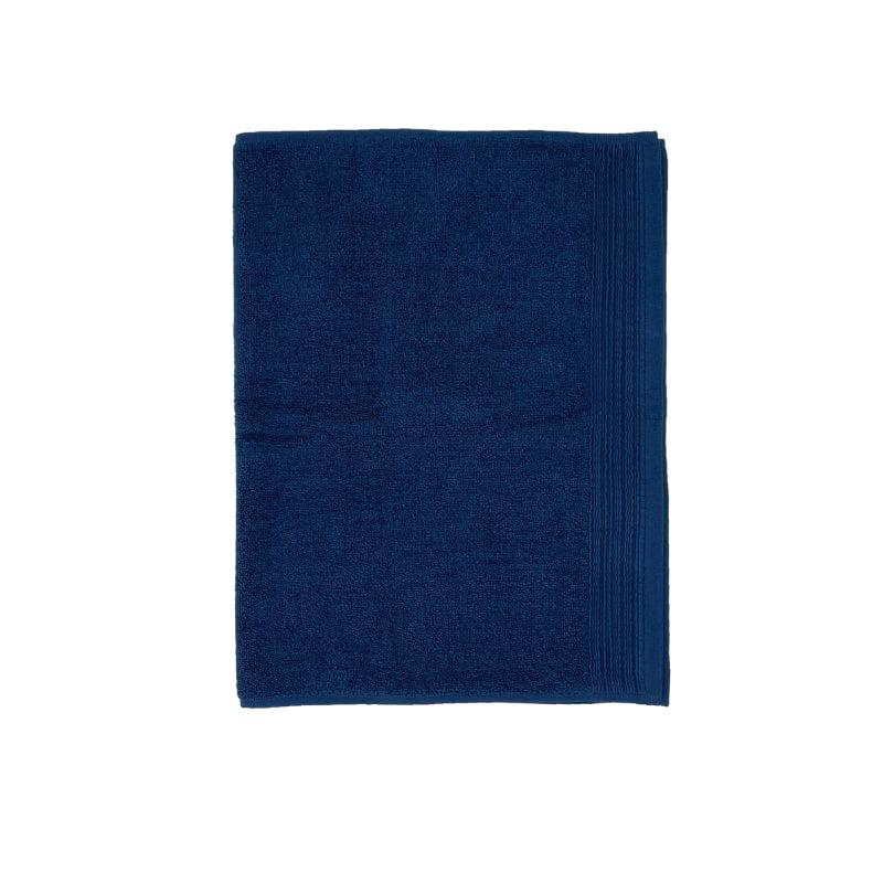 A soft navy bath mat enhancing the calm and luxurious feel of a spa-inspired bathroom.