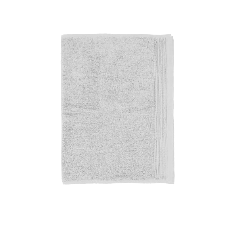 A soft white bath mat enhancing the calm and luxurious feel of a spa-inspired bathroom.