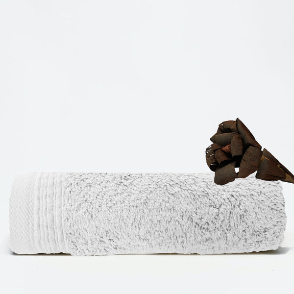 A white face towel showcasing elegance with a wide sheared border for a luxurious touch.