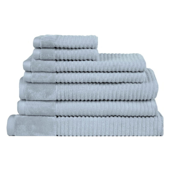 A neatly arranged stack of soft baby blue towels, embodying opulence and comfort for a bathroom's serene atmosphere.