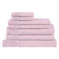 A collection of soft baby pink towels arranged neatly, adding a touch of elegance to any bathroom decor.