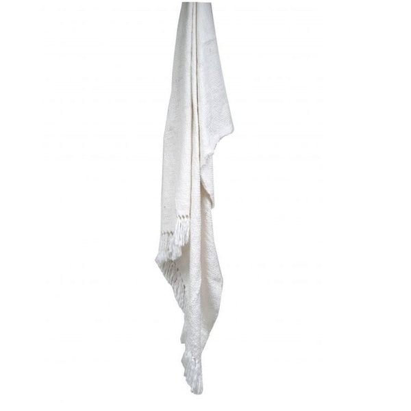 A white throw elegantly draped on a pristine white wall, showcasing simplicity and cleanliness in design.