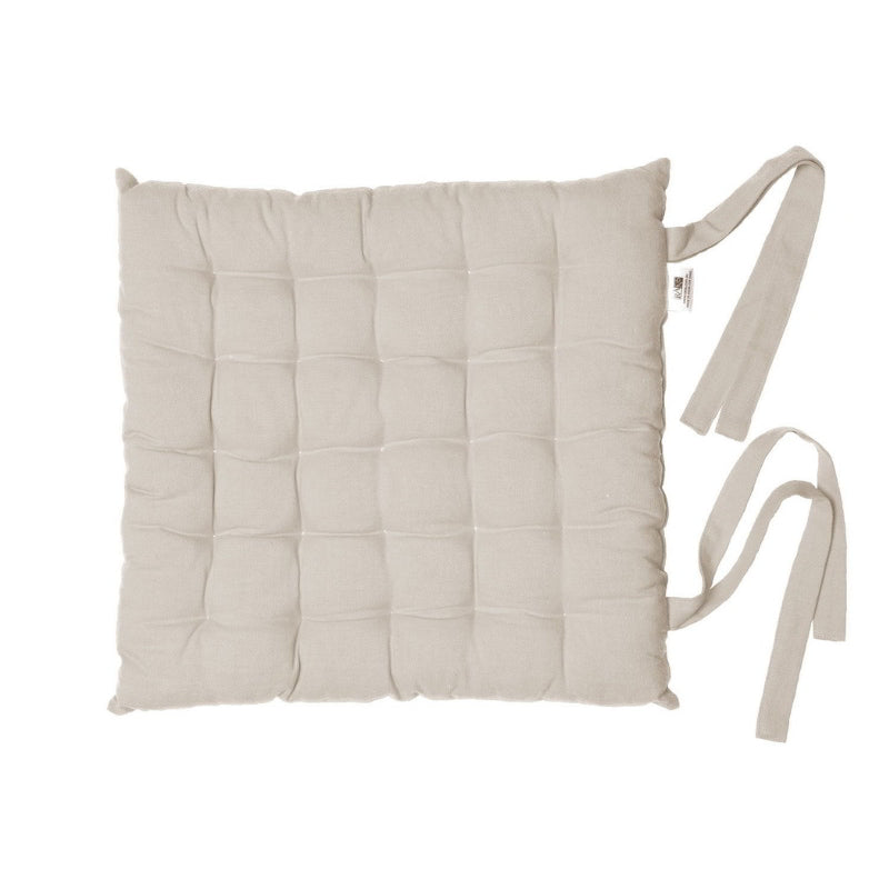 An oatmeal chair pad with a strap, ideal for adding comfort and elegance to both indoor and outdoor seating.