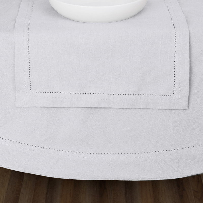 Close up details of hemstitch white tablecloth enhancing the dining experience with timeless style and functionality.