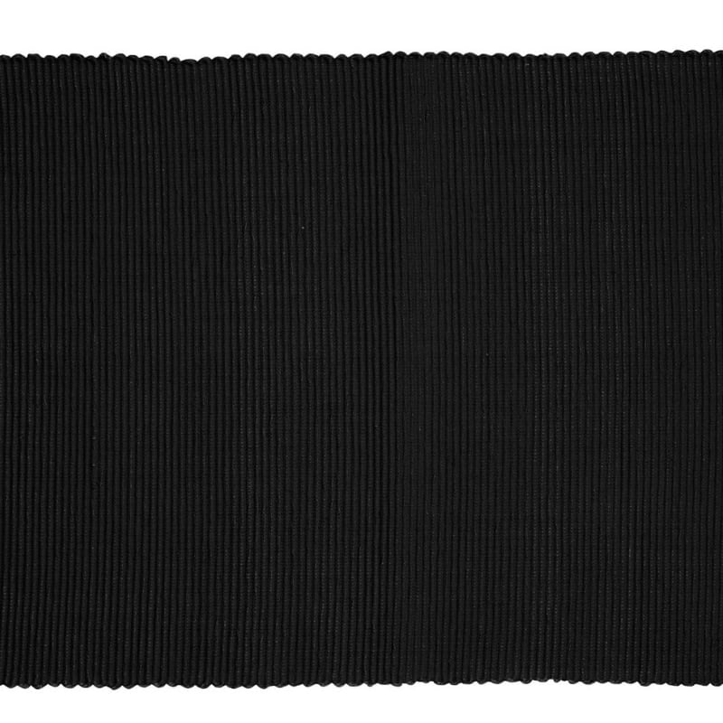 A sophisticated black ribbed placemat, enhancing dining experiences with style and protection.