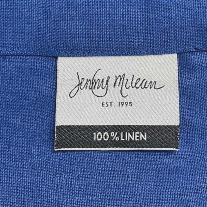 Front tag details of Venice indigo linen napkin emphasizing the fabric used.