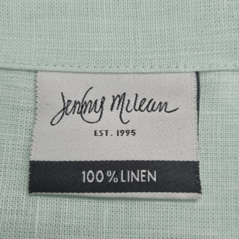 Front tag details of Venice mist linen napkin emphasizing the fabric used.